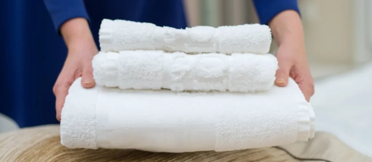 Towels being arranged for hospitality use